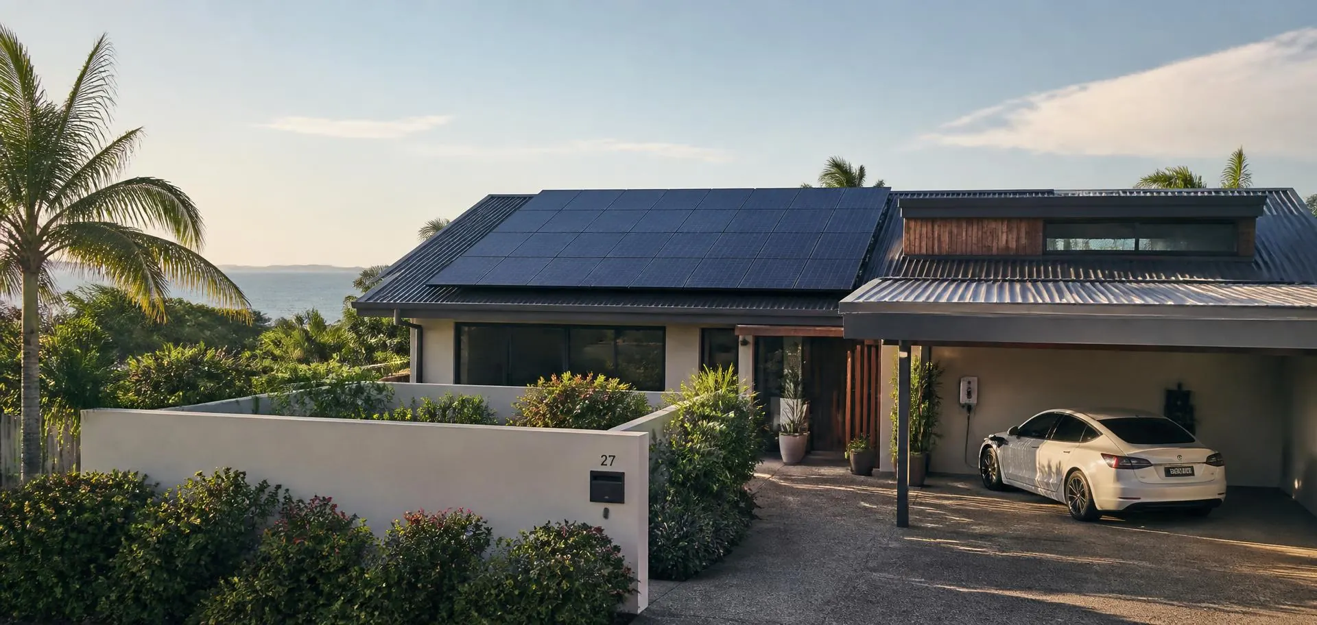 New South Wales home with rooftop solar panels and an electric car charging in the carport in afternoon light